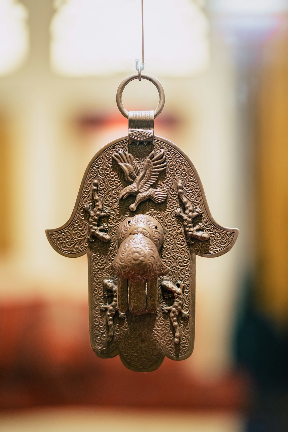shallow focus photography of silver-colored Hamsa Hand pendant