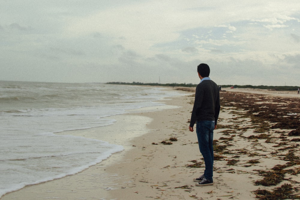 man standing at beach during daytime