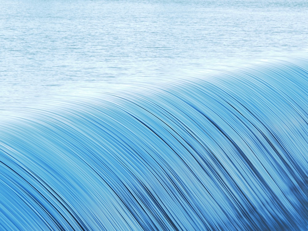 a man riding a wave on top of a surfboard