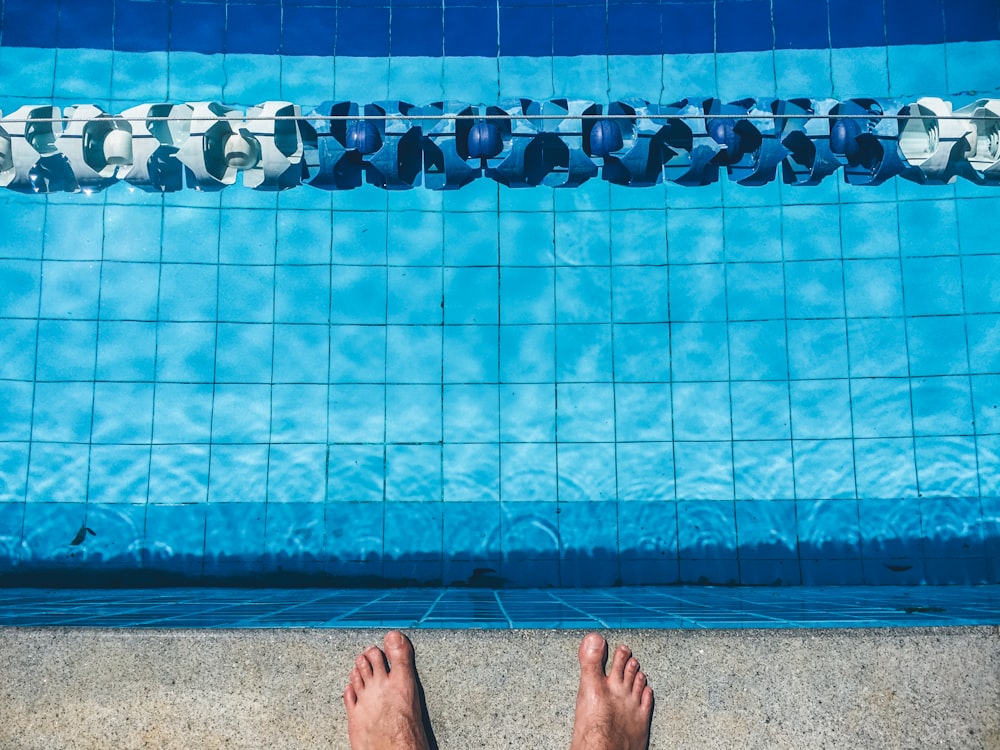 person standing on edge of pool