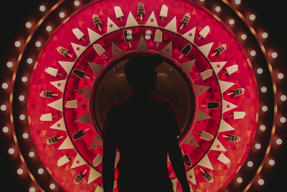 silhouette photography of man standing in front of wallpaper