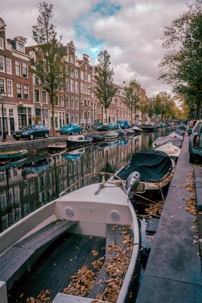 white and gray boat docked near buildings