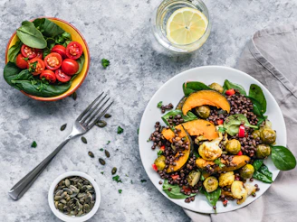 brussels sprout salad and red tomatoes with fork on table