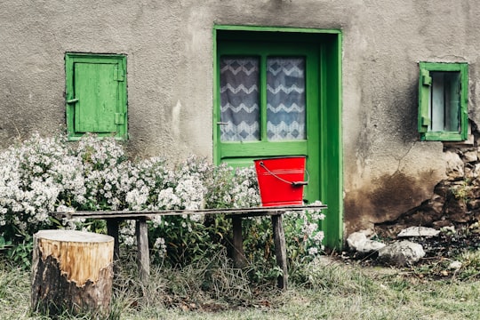 red metal bucket on bench outdoors in Cluj County Romania