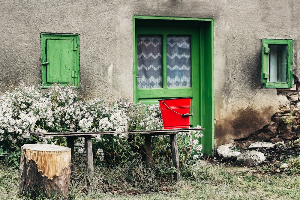 red metal bucket on bench outdoors