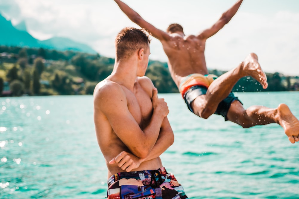 man diving on ocean during daytime