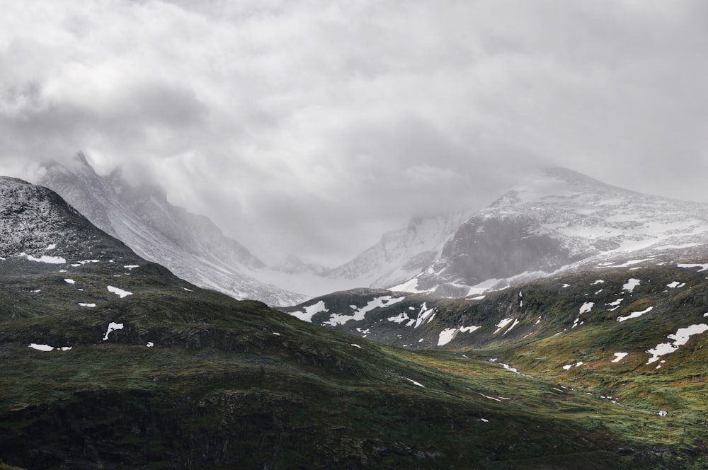 snow covered mountain under white clouds