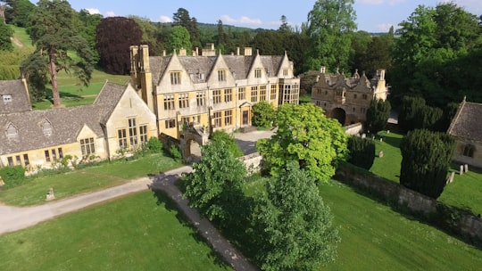 beige painted house and grass field in Stanway House United Kingdom