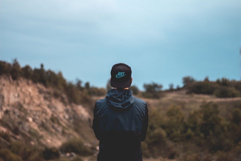 man standing against brown field