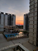 A stunning aerial view of a luxury residential complex in Delhi at sunset.