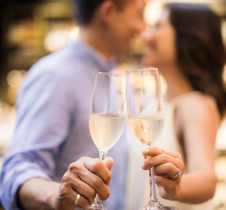 selective focus photography of couple holding cocktail glasses