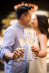 selective focus photography of couple holding cocktail glasses