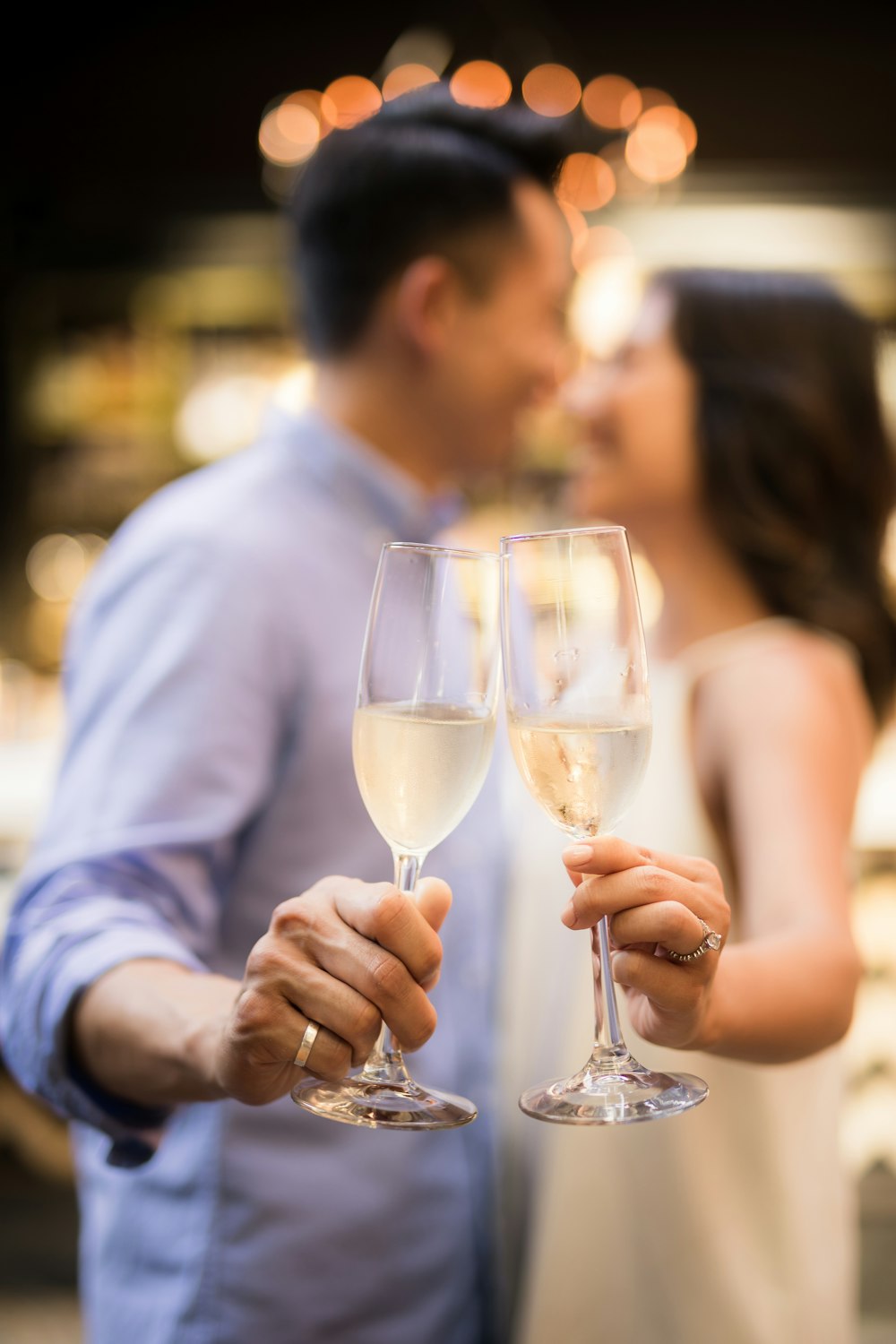 selective focus photography of couple holding cocktail glasses