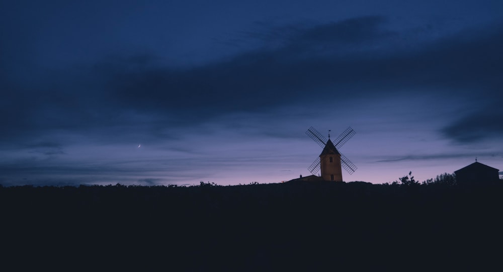 white windmill during sunset