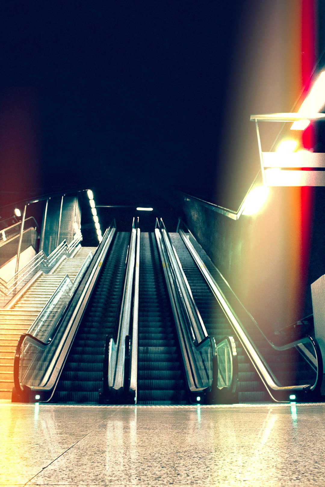 black escalator beside stair