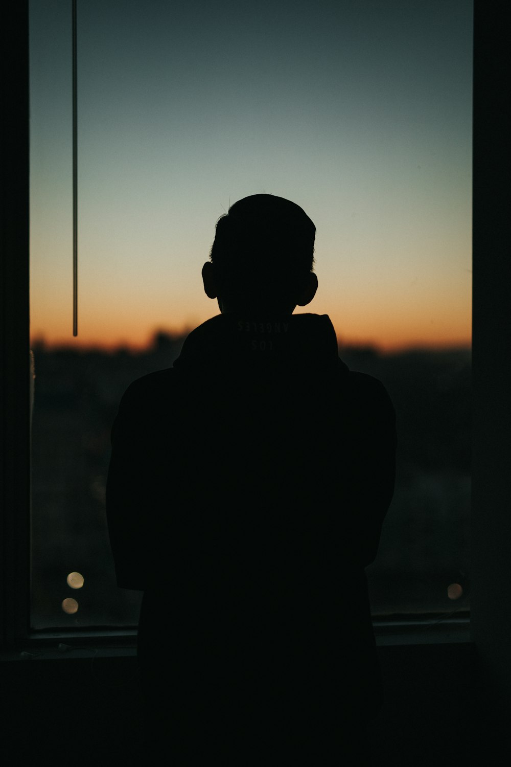 man standing front of glass window