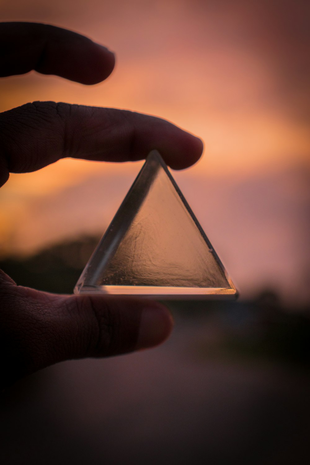 person holding triangle glass panel
