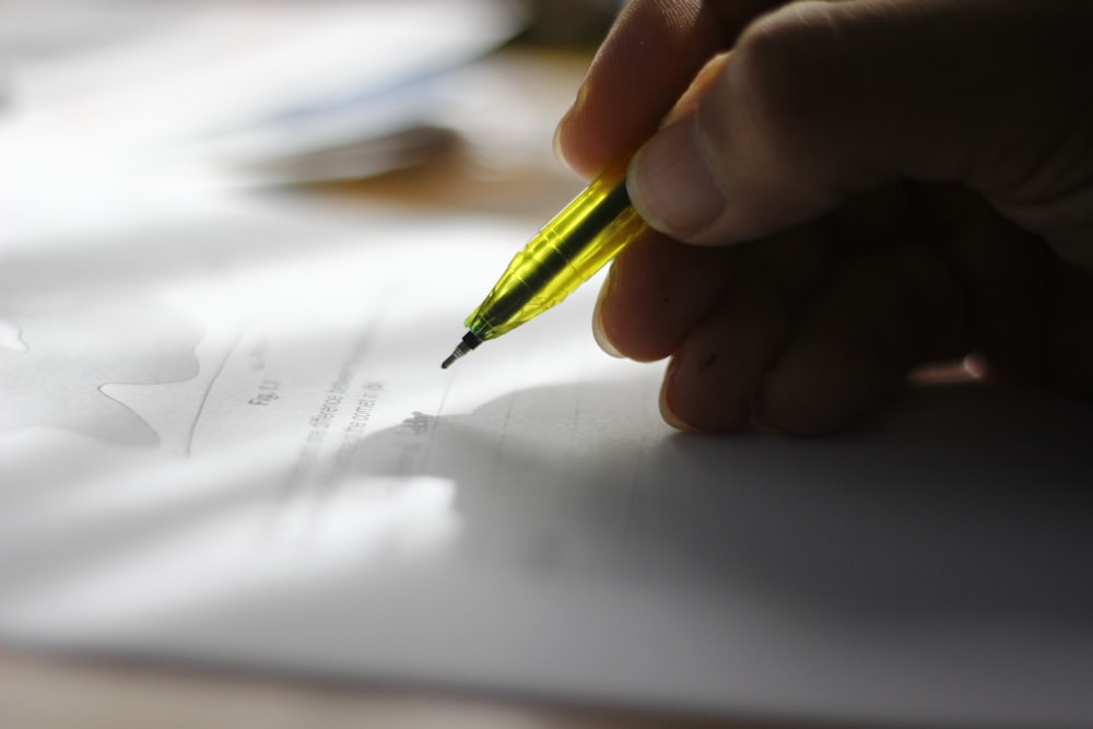 person about to write on piece of paper