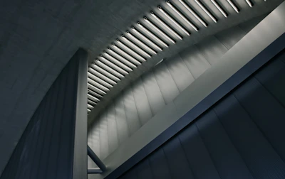 Modern office interior illuminated with sleek linear lighting emphasizing architectural details.