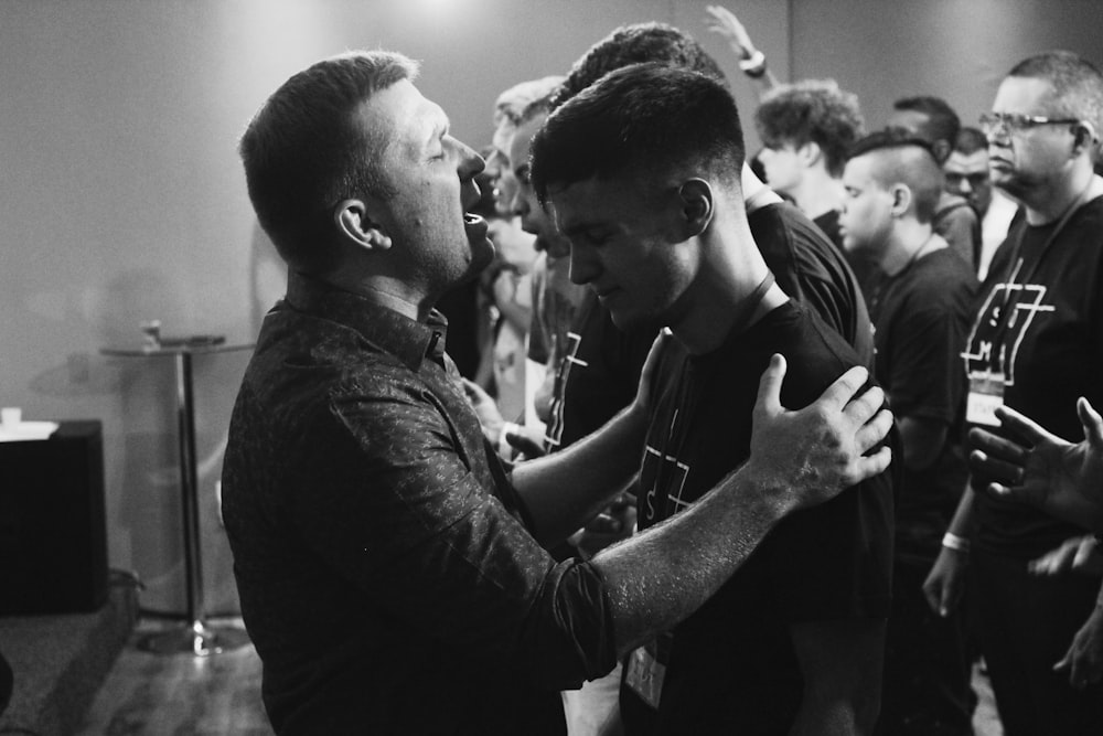 grayscale photo of two men facing each other