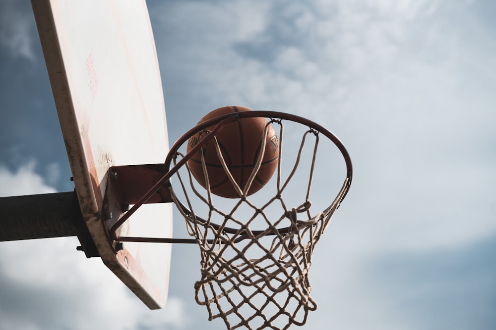 brown basketball ball on black and gray basketball hoop