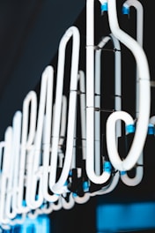 Close-up of neon chemical tubes glowing under dark light.