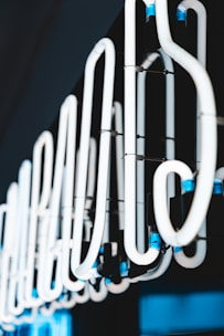 Close-up of neon chemical tubes glowing under dark light.