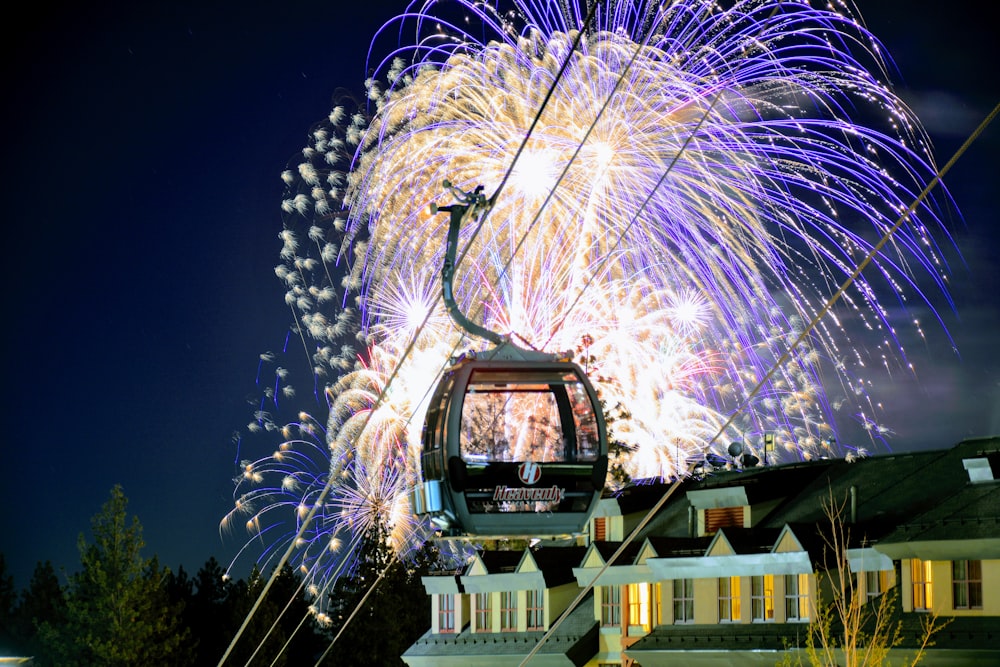 long exposure photography of cable car under white and blue fireworks