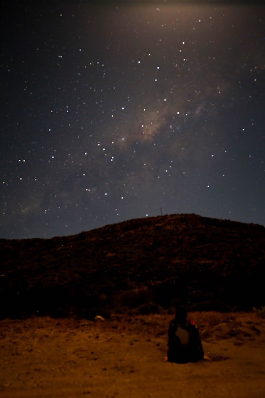 person sitting under starry sky at night in Exmouth Australia