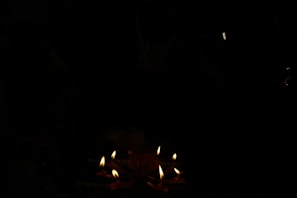 An atmospheric setting with lit candles and subtle shadows.