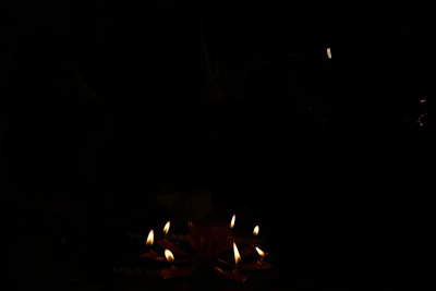 A cozy setting featuring several artisanal candles arranged on a table with soft shadows