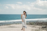 Photo of a light, airy beach dress on a sandy shore.
