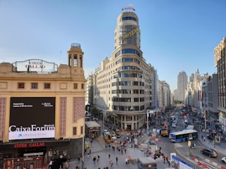 group of people walking beside road and buildings