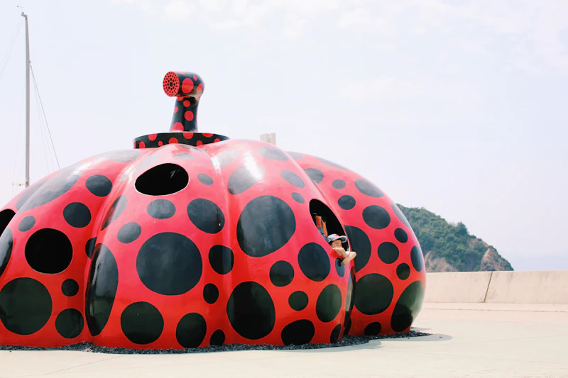 Yayoi Kusama red pumpkin installation at the Miyanoura ferry pier on Naoshima Island, Kagawa, Japan