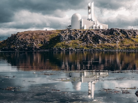 white painted building on island scenery in Stykkishólmur Iceland