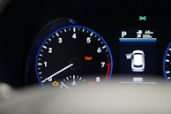 Diagnostic equipment connected to a car engine showing detailed readings on a screen.