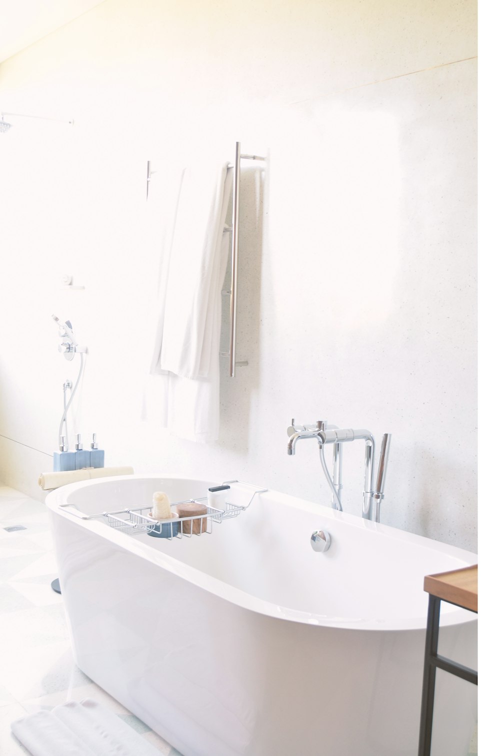 white drop-in bathtub near bath towel