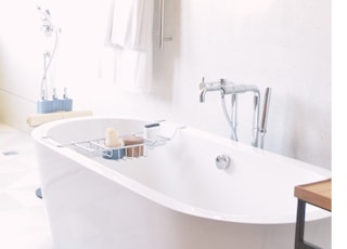 white drop-in bathtub near bath towel