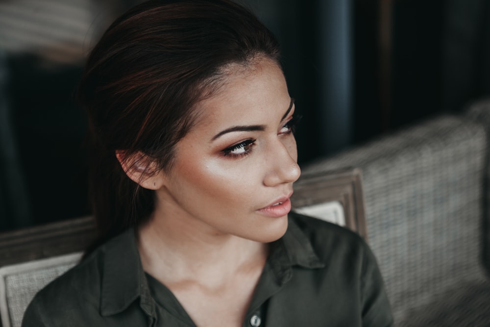 woman in black collared top on selective focus photography