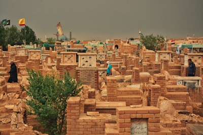 Wide view of the Al Azhar Memorial Garden showing orderly rows of graves and shaded walkways.