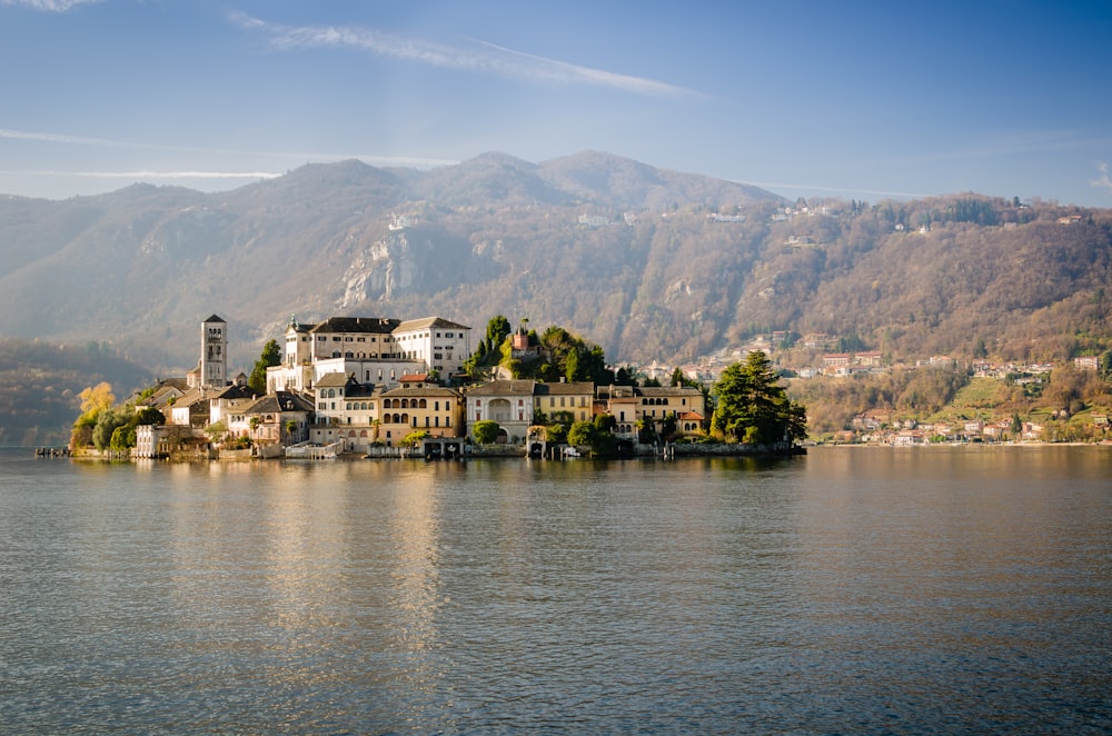 concrete buildings surrounded by body of water during daytime