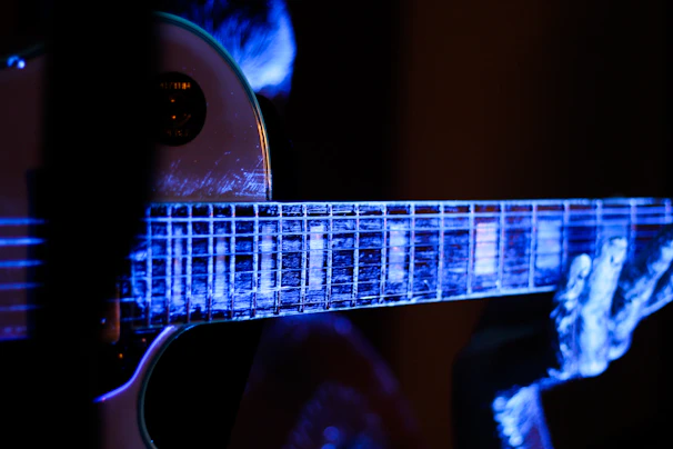 Close-up of Ebenru playing guitar during a worship session