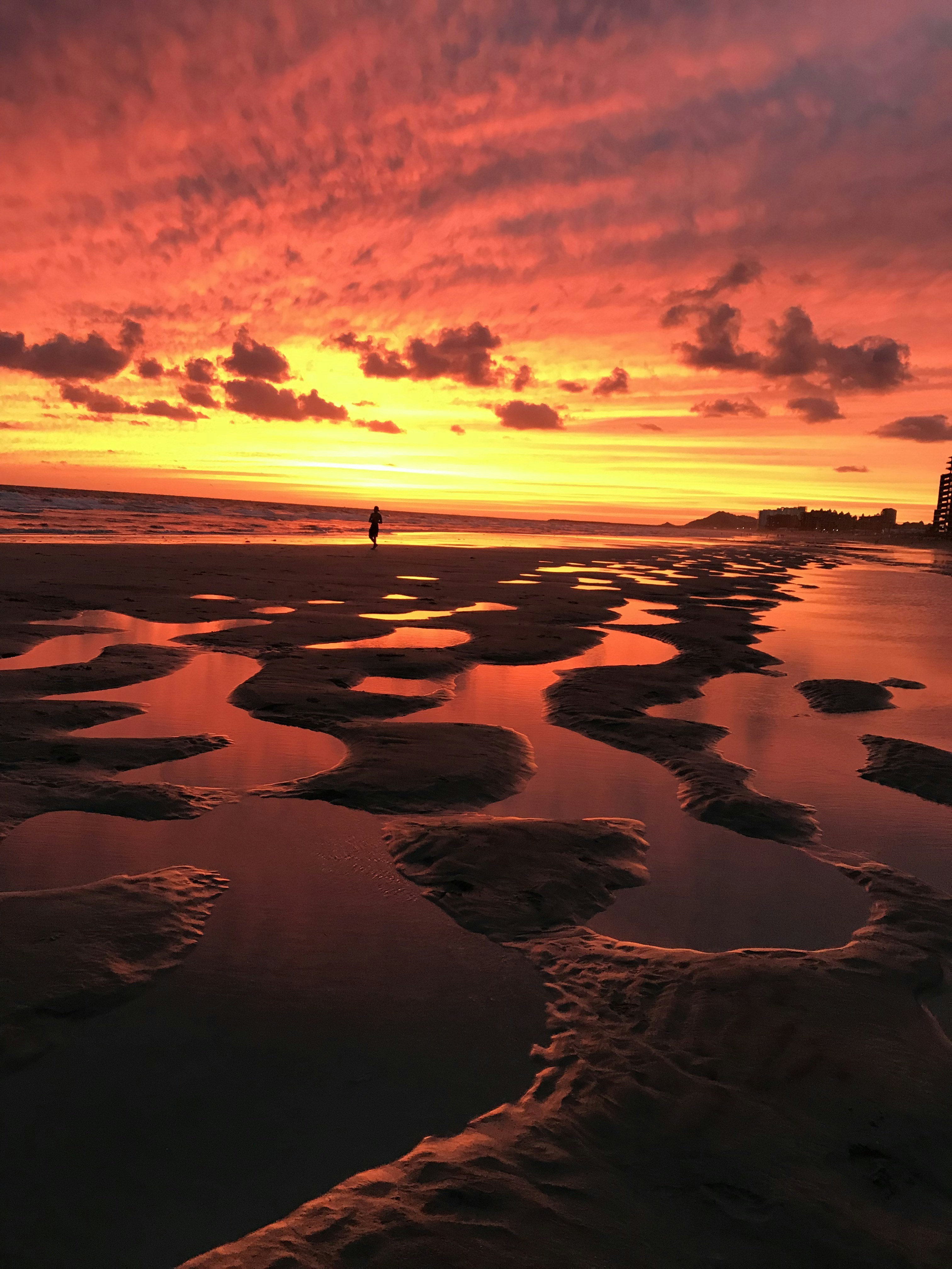 Racing Hobie 18 at Rocky Point, MX. Everyone meets at the camping retainer wall for drinks and sunsets. This is my most recent one this October, 2018. Low tides reflect the sunset. I call it my RED SUNSET in Mexico.