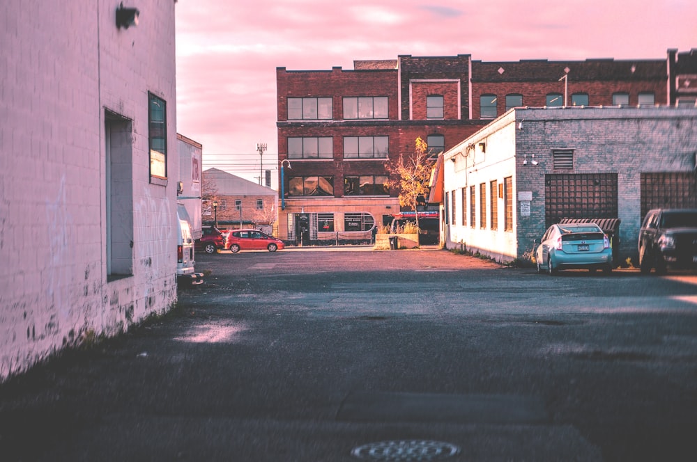 cars parked near gray concrete building during daytime