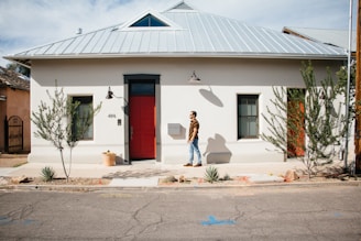 man standing outside his house
