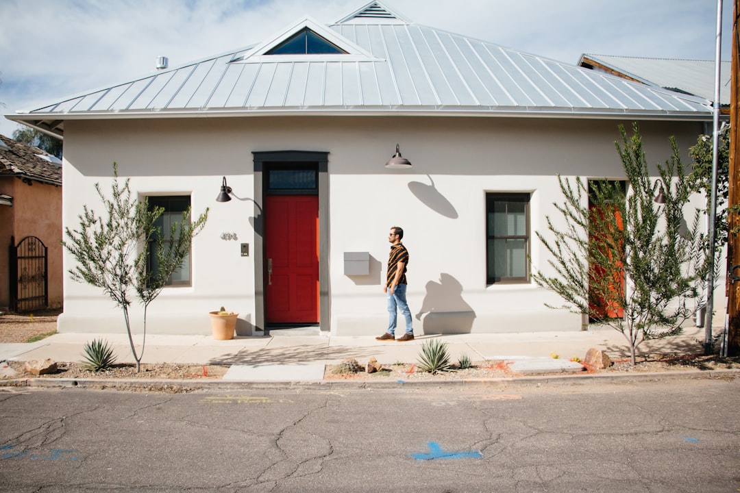 man standing outside his house