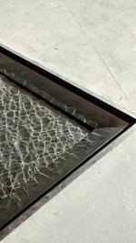 a metal tray with water running down it