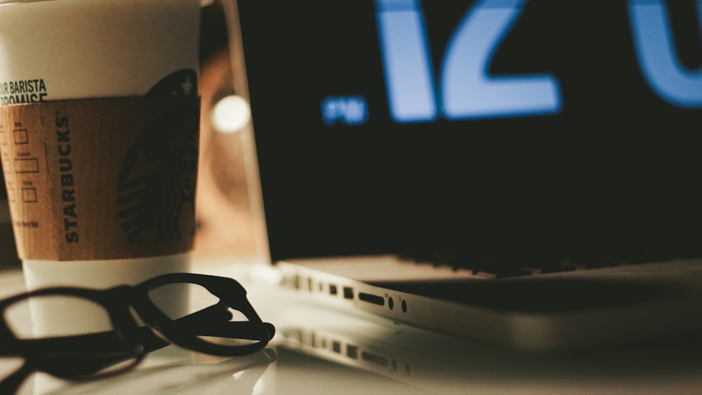 eyeglasses beside laptop computer