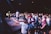 An audience enjoying a live music performance with smiles and dancing.