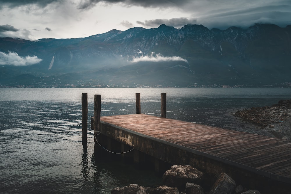 brown wooden dock near mountain